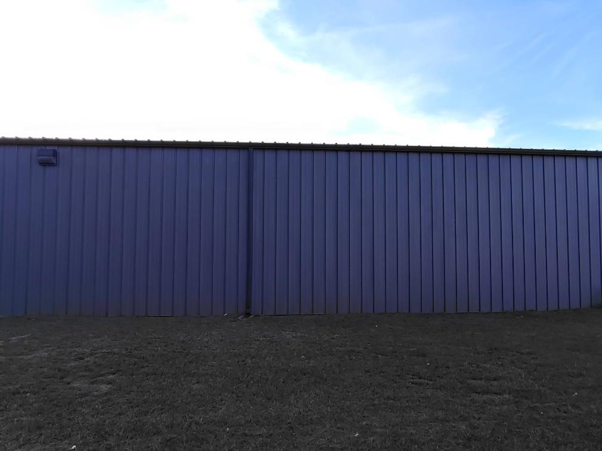 Commercial metal building exterior in gray after pressure washing